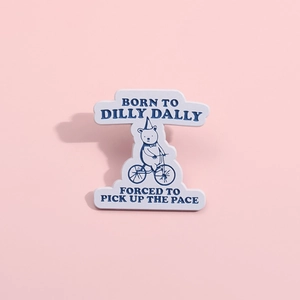 Cartoon bear on bicycle enamel pin with humor text on pink background