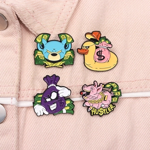 Detailed view of four cartoon enamel pins styled on a pink denim jacket pocket
