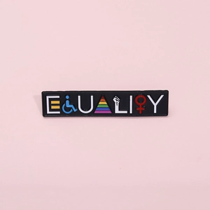 Macro shot of Equality enamel pin featuring rainbow symbols on a black metal base