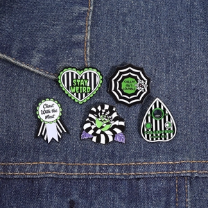 Detailed close-up of 5-piece gothic enamel pins set featuring green and black striped patterns