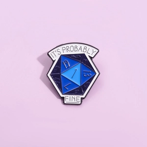 Detail of blue D20 dice enamel pin with 'It's Probably Fine' slogan on purple background