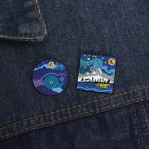Detail of artistic Van Gogh style enamel pins on blue denim fabric, Hobbit door and silhouette