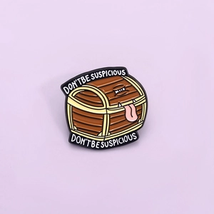Detail of RPG Mimic chest enamel pin featuring the text Don't Be Suspicious