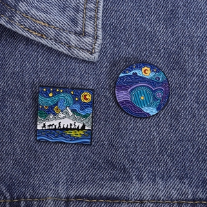 Detailed enamel pins featuring Van Gogh starry night style Middle Earth scenes on denim
