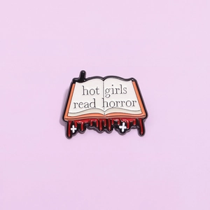 Cute book enamel pin with hot girls read horror text and blood drip design