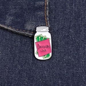 Detailed close-up of Douchebag Jar enamel pin on denim fabric showing metal textures