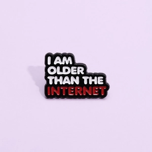 Funny enamel pin badge with 'I AM OLDER THAN THE INTERNET' slogan on purple background