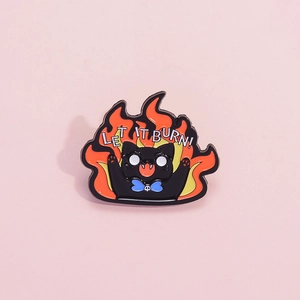 Cartoon black cat enamel pin with flames and Let It Burn text on pink background