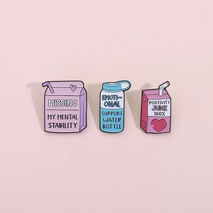 Three creative metal pins featuring cute milk carton and water bottle designs for backpacks