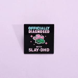 Pink cowboy hat green frog enamel pin featuring SLAY-DHD text on a black background