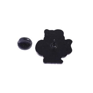 Close-up of black enamel pin back featuring secure rubber clutch on a metal badge