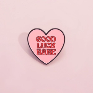Pink heart enamel pin with Good Luck Babe lettering and vintage black metal trim