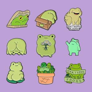 Set of 9 cute cartoon frog enamel pins with puns on a soft purple background