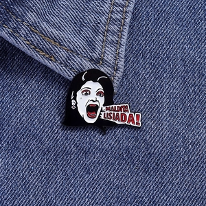 Close-up of Maldita Lisiada enamel pin on blue denim jacket with comic character