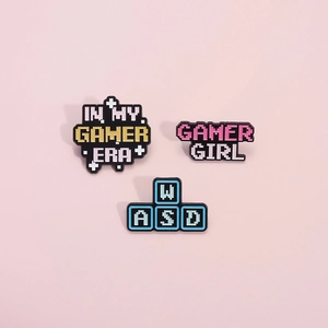 Three-piece pixel art enamel pin set featuring Gamer Era and WASD gaming keyboard keys