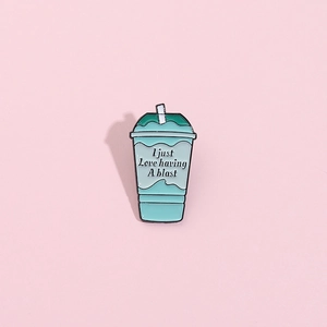 Creative mint green beverage cup enamel pin badge with straw design and text on pink background