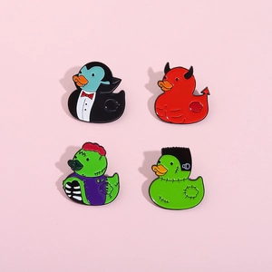 Set of four Halloween rubber duck enamel pins including vampire, devil, and zombie designs