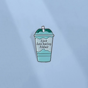 Enamel drink cup brooch with teal and blue tones and I Just Love Having A Blast text