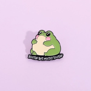 Cute green frog enamel pin badge with Rootin' But Mostly Tootin' text for backpacks