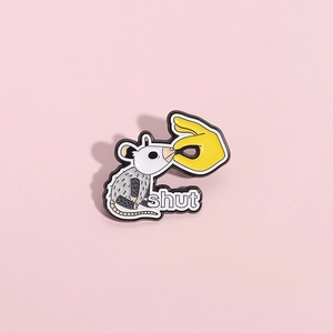 Creative enamel mouse pin with hand and shut text on a pink background