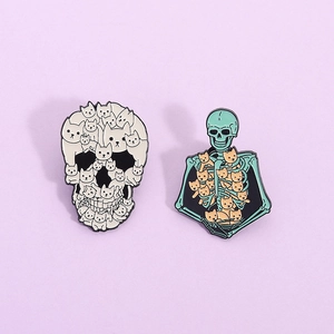 Cute set of two cat skull enamel pins in mint green and cream white for clothing