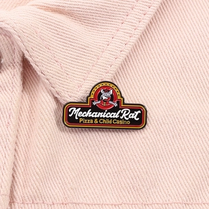 Detailed close-up of Mechanical Rat Pizza enamel pin on pink denim fabric texture