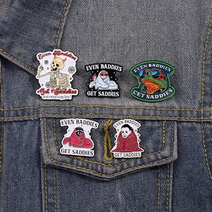 5-piece punk skull and cat enamel pin set pinned on a blue denim jacket pocket