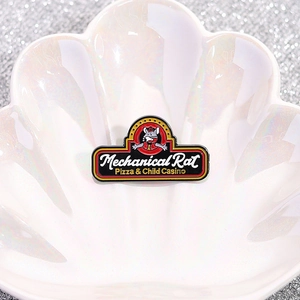 Mechanical Rat enamel pin with vintage cartoon style on a decorative shell tray
