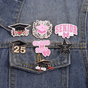 7-piece set of Class of 2025 graduation enamel pins with black and pink doctoral caps