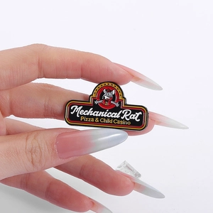 Detail of hand-held Mechanical Rat Pizza enamel pin badge with crisp English lettering