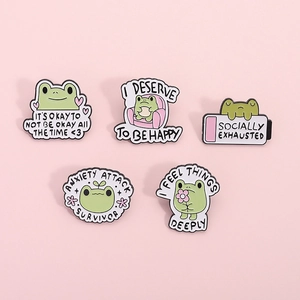 5-piece cute green frog enamel pin set with mental health themes on pink background