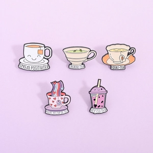 Set of 5 colorful enamel tea cup pins featuring cute slogans on a lilac background