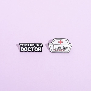 Cartoon enamel medical badges featuring Trust Me I'm a Doctor and Nurse hat designs