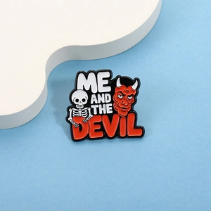Detailed view of enamel pin with skull, red devil and ME AND THE DEVIL text