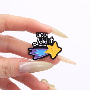 Cartoon enamel pin with 'you did it' text and yellow star for motivational decor
