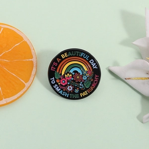 Rainbow and flower enamel pin with slogan It's a Beautiful Day to Smash the Patriarchy