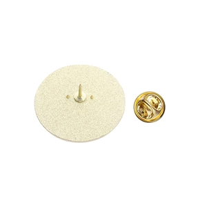 Detail view of the metal brooch back featuring a textured base and golden butterfly clasp