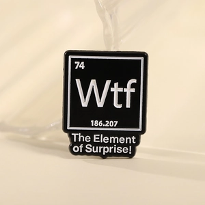 Detailed close-up of a black square WTF enamel pin with periodic table design and text