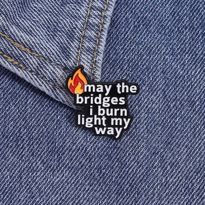 Detailed macro view of enamel flame badge with quote on blue denim fabric background