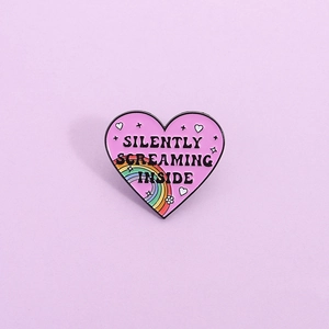 Pink heart enamel pin with rainbow and Silently Screaming Inside slogan metal badge