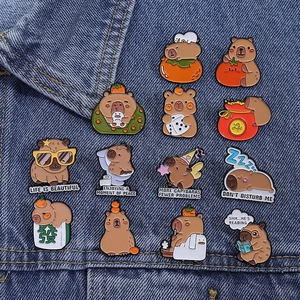 Détail de pins capybara mignons en émail sur veste en jean montrant des couleurs vives