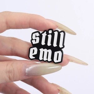 Classic black and white enamel pin featuring bold still emo lettering for apparel decoration
