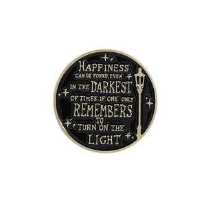 Enamel wizard pin with inspirational quote and street lamp on black background