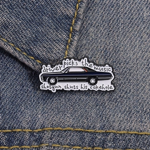 Detailed close-up of a Supernatural enamel pin with a black car on a denim jacket
