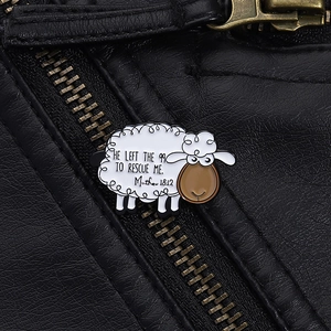 Detail of cartoon sheep enamel pin with religious quote on black leather jacket zipper