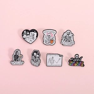Halloween skull enamel pin set with stay weird text on a minimalist pink background