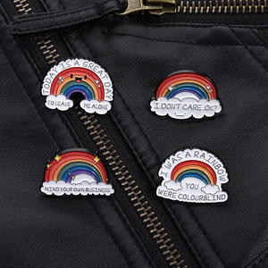 Rainbow enamel lapel pins set on black leather jacket with vibrant color contrast