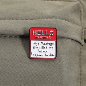 Classic 'Hello My Name Is' red and white enamel pin with iconic movie quote on canvas