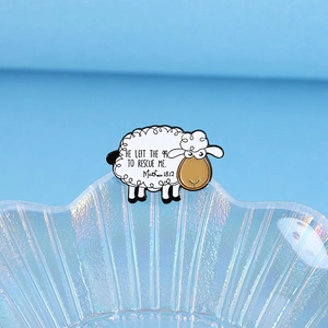White sheep enamel pin with Matthew 18:12 bible quote on a shell glass dish