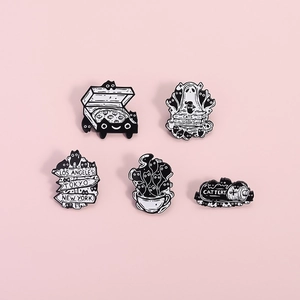 5-piece set of minimalist black cat and ghost enamel pins on a soft pink background